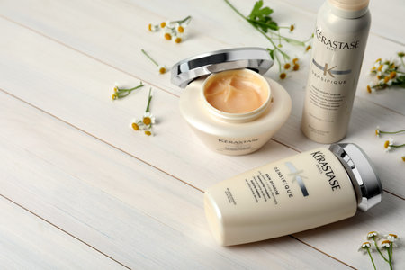 MYKOLAIV, UKRAINE - SEPTEMBER 07, 2021: Set of Kerastase hair care cosmetic products on white wooden table. Space for textのeditorial素材