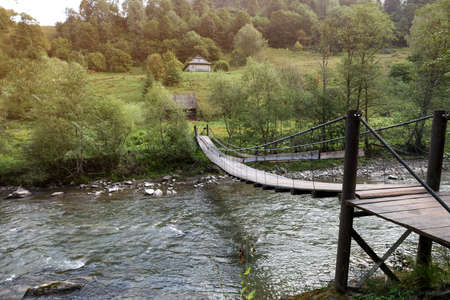 Beautiful view of wooden bridge over river in morningの写真素材