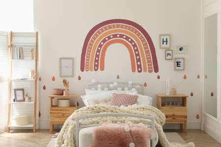 Stylish child's room interior with comfortable bedの写真素材