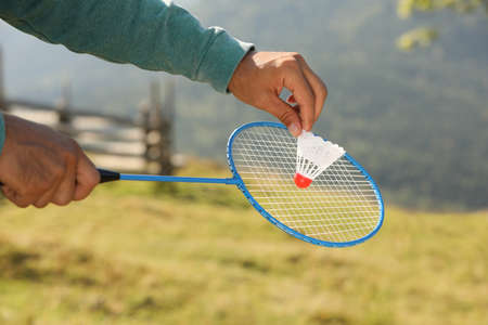 Man playing badminton outdoors on sunny day, closeupの写真素材
