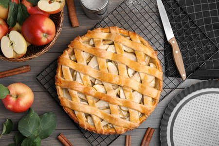 Delicious traditional apple pie on wooden table, flat layの写真素材