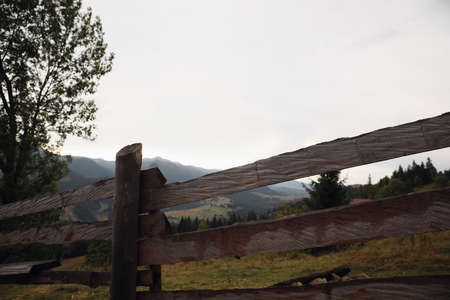 Beautiful view of mountain countryside with wooden fenceの写真素材