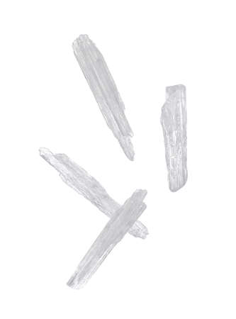 Translucent menthol crystals falling on white backgroundの写真素材