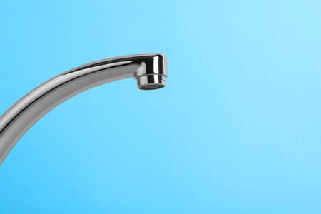 Modern water tap on light blue background, closeup. Space for textの写真素材