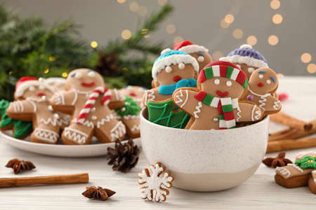 Delicious homemade Christmas cookies on white wooden table against blurred festive lightsの写真素材