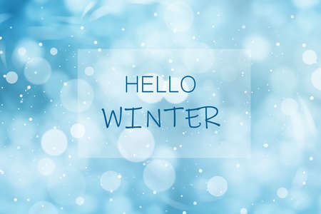 Phrase Hello Winter and snowfall on light blue background, bokeh effectの写真素材