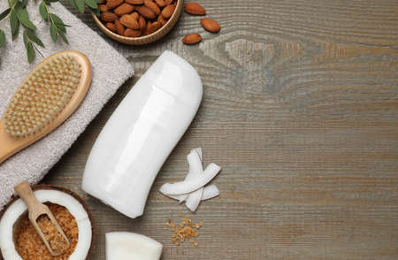 Flat lay composition with bottle of shower gel on wooden table. Space for textの写真素材