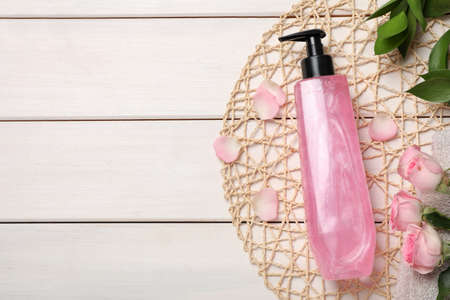Flat lay composition with bottle of shower gel on white wooden table. Space for textの写真素材
