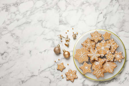 Tasty Christmas cookies and baubles on white marble table, flat lay. Space for textの写真素材