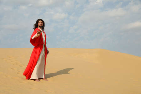 Jesus Christ with outstretched hand in desert. Space for textの写真素材