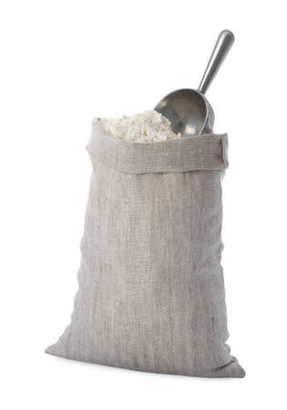 Sack with flour and scoop isolated on whiteの写真素材