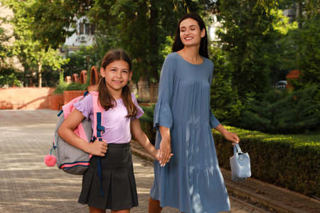 Mother taking her daughter to school in morningの写真素材