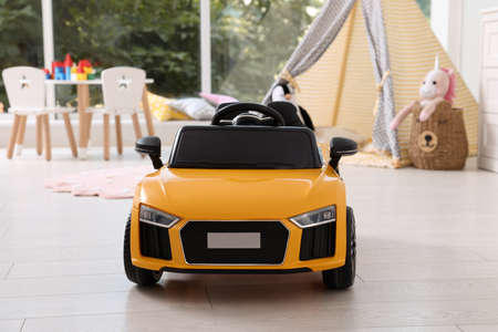 Yellow car in room at home. Child's toyの写真素材