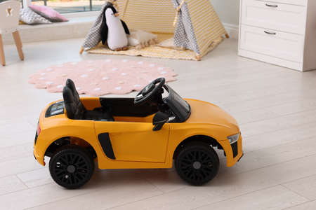 Yellow car in room at home. Child's toyの写真素材
