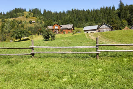 Beautiful view of mountain countryside with wooden fenceの写真素材