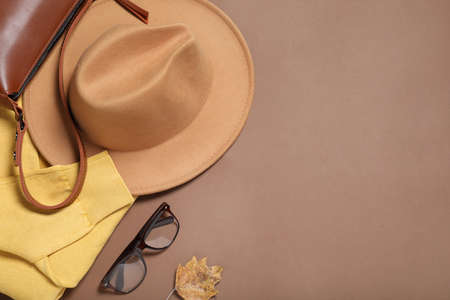 Flat lay composition with stylish hat on brown background, space for textの写真素材