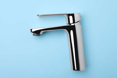 Single handle water tap on light blue background, top viewの写真素材