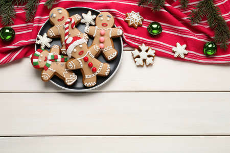 Delicious Christmas cookies and festive decor on white wooden table, flat lay. Space for textの写真素材