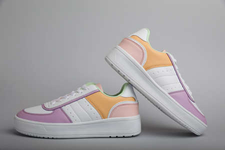 Pair of comfortable sports shoes on gray backgroundの写真素材