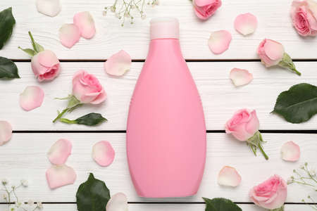 Flat lay composition with bottle of shower gel on white wooden tableの写真素材