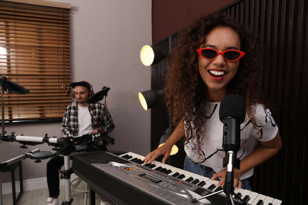 Music band performing in modern recording studioの写真素材