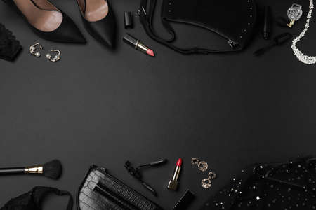 Women's clothes, makeup products and accessories on dark background, flat lay with space for text. Black Friday saleの写真素材