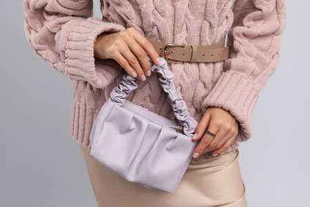 Fashionable woman with stylish bag on light background, closeupの写真素材