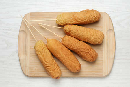 Delicious deep fried corn dogs on white wooden table, top viewの写真素材
