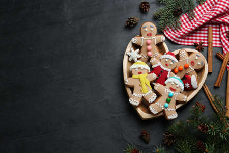 Flat lay composition with delicious Christmas cookies on black table, space for textの写真素材
