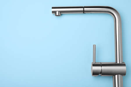 Modern pull out kitchen faucet on light blue background, top view. Space for textの写真素材
