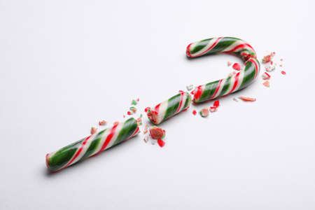 Broken sweet Christmas candy cane on white backgroundの写真素材