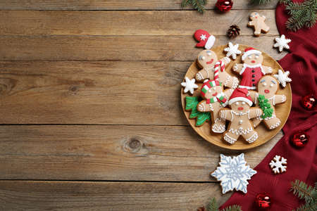 Delicious Christmas cookies and festive decor on wooden table, flat lay. Space for textの写真素材