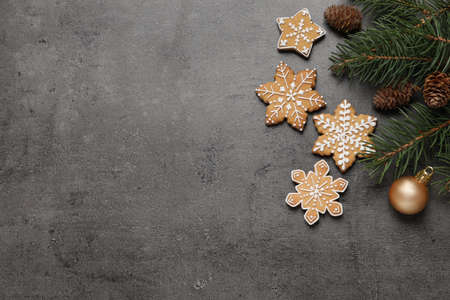 Tasty Christmas cookies, fir branches and festive decor on gray table, flat lay. Space for textの写真素材