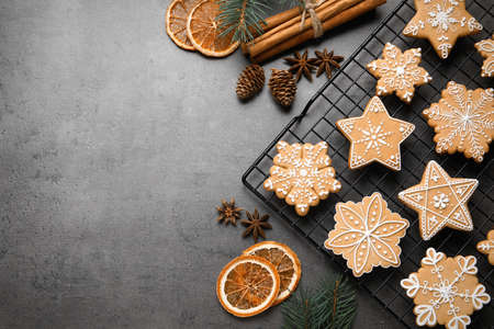 Tasty Christmas cookies and festive decor on gray table, flat lay. Space for textの写真素材