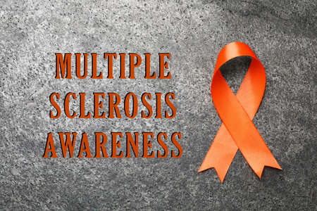 Multiple Sclerosis Awareness Day. Orange ribbon on gray background, top viewの写真素材