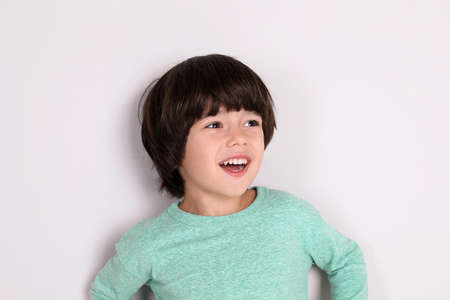 Portrait of cute little boy on white backgroundの写真素材