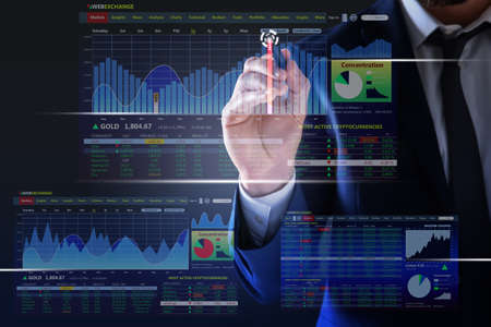 Stock exchange. Businessman pointing at virtual screen electronic online trading platform, closeupの写真素材