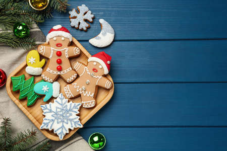 Flat lay composition with delicious Christmas cookies on blue wooden table, space for textの写真素材