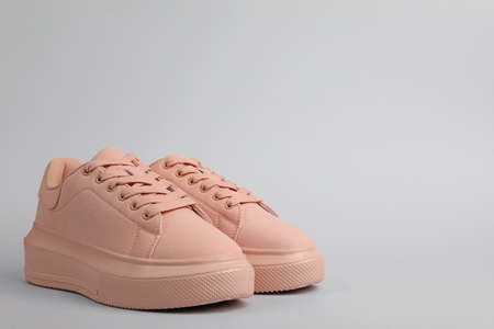 Pair of comfortable sports shoes on gray background. Space for textの写真素材