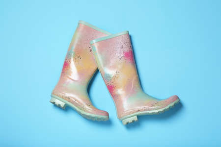 Pair of rubber boots on light blue background, top viewの写真素材
