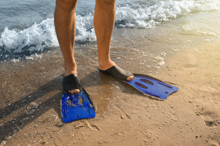 Man in flippers on sandy beach, closeupの写真素材