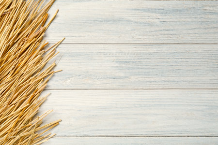 Dried hay on white wooden background, flat lay. Space for textの写真素材