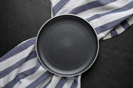 New clean plate and napkin on black table, top viewの写真素材