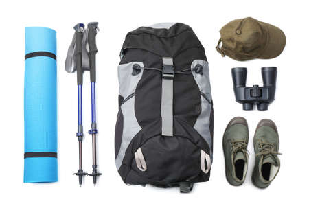 Pair of trekking poles and camping equipment for tourism on white background, top view