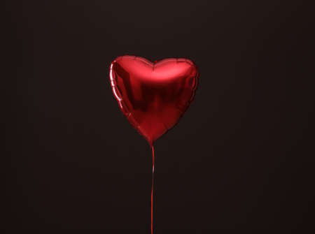 Festive heart shaped balloon on dark backgroundの写真素材