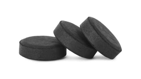 Activated charcoal pills on white background. Potent sorbentの写真素材