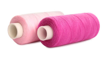 Different colorful sewing threads on white background, closeup