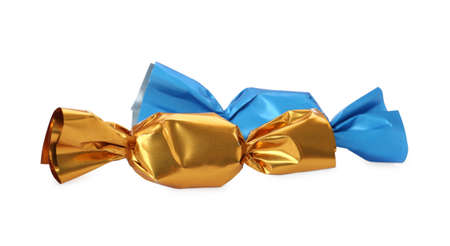 Delicious candies in colorful wrappers on white backgroundの写真素材