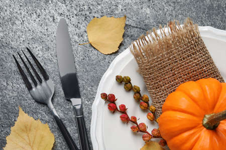 Festive table setting with autumn decor on gray background, flat layの写真素材