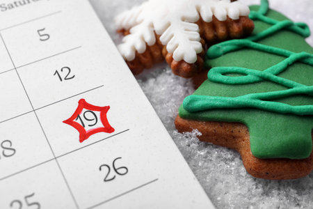 Saint Nicholas Day. Calendar with marked date December 19 and gingerbread cookies on snow, closeupの写真素材